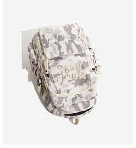 Detail view of trendy grey camo backpack, showing embroidered letters and multiple compartments.
