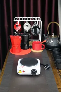 Compact 500W electric heating stove detail setup with moka pots and coffee cups scene.