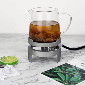 Mini electric stove with glass teapot for tea brewing, compact desktop electric burner for home.