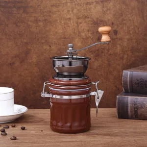Manual coffee grinder detail view, retro design with glass jar and wooden handle for home use.