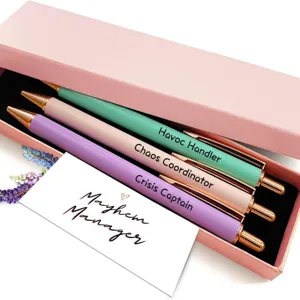 Detailed view of a metal ballpoint pen gift box set featuring three colorful custom quote pens.
