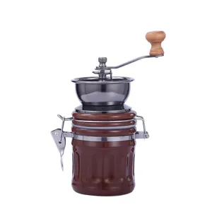 Portable manual coffee grinder with ceramic jar, stainless steel hopper and wooden handle.