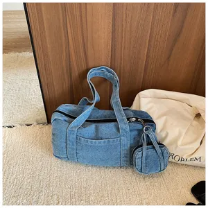Distressed washed denim casual tote bag detail showing texture, zipper, and matching mini pouch.