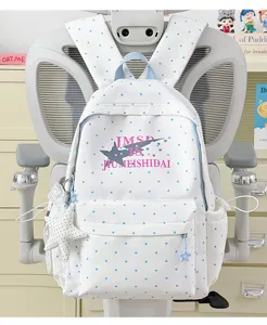 Polka dot student backpack close-up detail, cute star print design, large daily school bag.