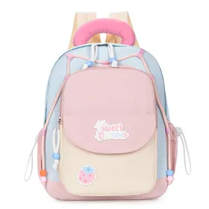 Detail shot of the cute color-block kids backpack with sweet patch and cozy pink handle.