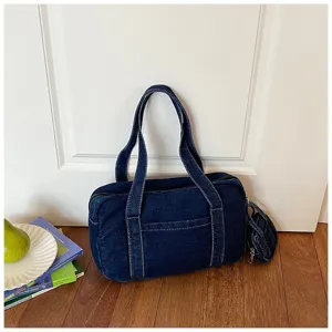 Close-up detail of the vintage dark blue denim tote bag, showcasing texture and sturdy stitching.