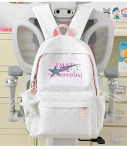 Cute white polka dot school backpack with star print and pendant for student daily use.