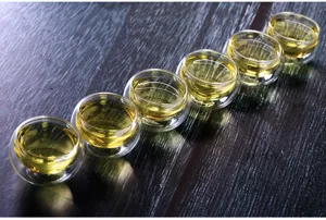 Detail shot of 50ml double-walled glass tea cups, clear heat-resistant kung fu tea glassware.