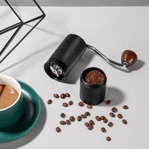 Moulin à café manuel portable avec meule en acier inoxydable et mouture réglable précise.