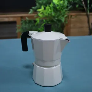 Detailed view of white double valve moka pot, classic octagonal espresso maker design.