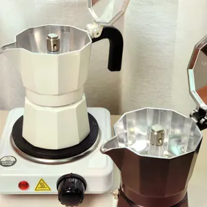 Dual valve moka pot espresso maker for home kitchen use. Classic stovetop coffee maker detail.