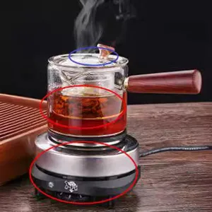 Exquisite glass teapot with wooden side handle and electric heating base for brewing tea.