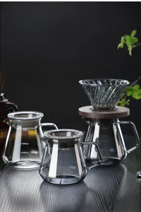 Glass pour over coffee maker set with wooden base and heat resistant glass server pot.