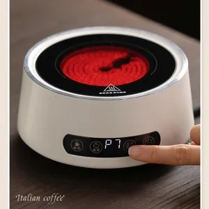 Plaque de cuisson electrique de menage pour cafe, design rond compact avec commande tactile.