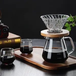 Glass pour-over coffee maker set with wooden holder, server pot and cups for kitchen.