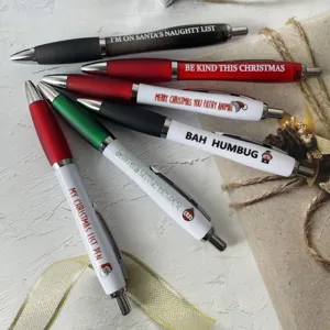 Detailed view of funny Christmas ballpoint pens set with festive quotes and icons.