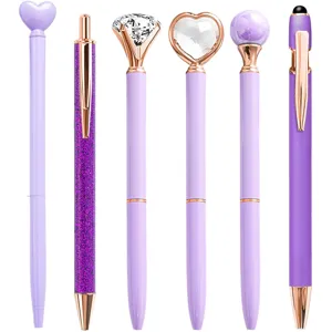 Set of 6 purple ballpoint pens with rose gold accents and decorative toppers like diamonds.