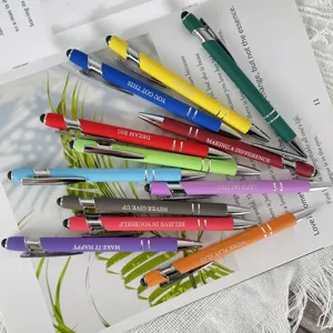 Colorful ballpoint pen set detail, inspirational text printed on barrels, stylus tips.