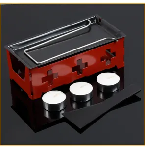 Portable mini cheese melting raclette grill set with candles and spatula for home use.