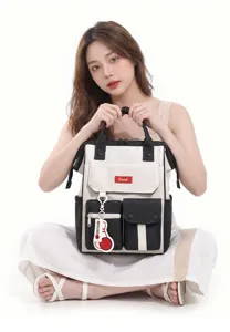 Stylish color-blocked multi-pocket casual backpack detail showcasing front design and hanging charm.