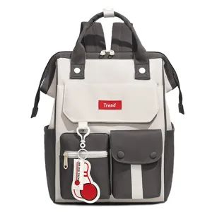 Casual contrast color multi-pocket backpack detail featuring trendy front badge and keychain.
