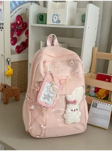 Niedlicher rosa College-Rucksack mit Sichtfenster und süßem Plüschhasen-Anhänger für Studenten.