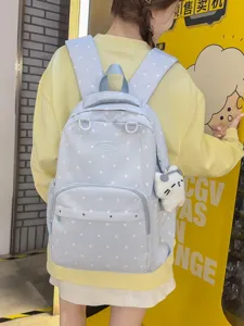 Sac à dos d'école à pois mignon pour femmes, grand sac de voyage pour étudiants avec pendentif.