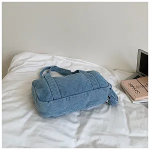 Vintage wash denim shoulder bag for women, casual barrel tote purse with spacious daily use.