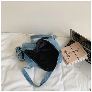 Detailed view of a vintage washed denim tote handbag with black lining and casual style.