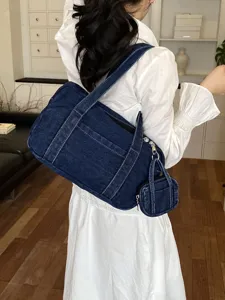 Classic vintage denim shoulder bag for women, stylish underarm commuter tote with coin pouch.