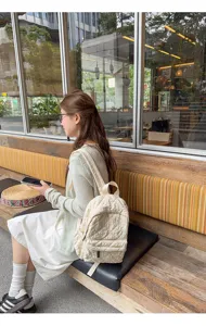 Detail view of the casual quilted backpack, lightweight daily commuter schoolbag style.