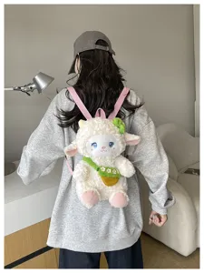 Cute lamb plush backpack detail view, fluffy white sheep school bag with pink straps and green pouch.
