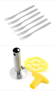 Stainless steel pineapple corer detail view showing the corer blade, handle, and fruit forks.