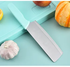 Kitchen knife detail shot with green handle, stainless steel blade on cutting board.