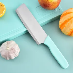 Stainless steel kitchen knife with blue handle and cutting board for outdoor cooking.