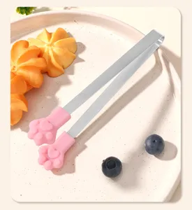 Stainless steel ice tongs with cute pink silicone cat paw grip for serving sugar and snacks.