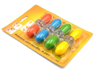 Detail view of the colorful double-headed stainless steel corn needle set in blister packaging.
