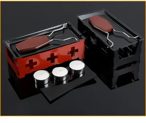 Mini cheese melting raclette grill set with metal tray, wooden handle spatula and candles.