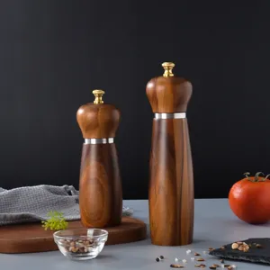 Manual wooden pepper and salt grinder set with metal ring, ideal for kitchen and dining table.