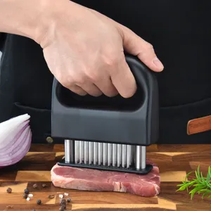 Stainless steel meat tenderizer tool with sharp needles for steak and kitchen cooking.