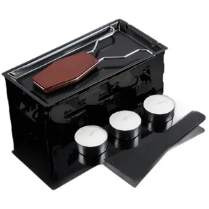 Mini stainless steel cheese raclette melting grill set with candles and wooden handle.