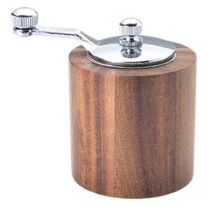 Manual wooden coffee and pepper grinder with metal hand crank for home and kitchen daily use.