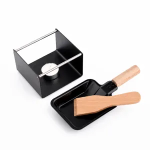 Mini cheese raclette grill set with non-stick baking pan and wooden spatula for home use.