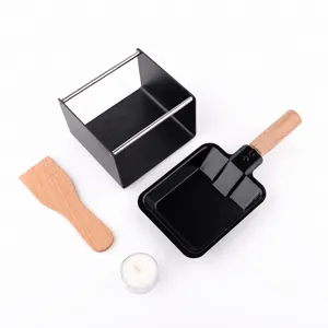 Mini cheese raclette grill set with non-stick pan, wooden spatula and candle for home kitchen.
