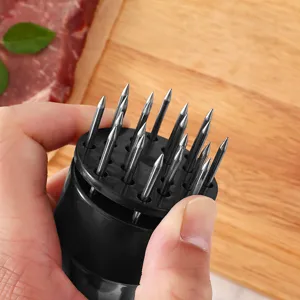 Stainless steel meat tenderizer tool with sharp needles and ergonomic black handle for kitchen.