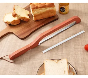 Detail view of wooden bread knife with serrated blade and guide strip on kitchen table.