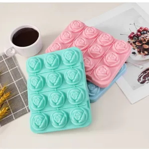 Detail view of 12 cavity silicone rose ice mold stacked with coffee cup and dessert magazine props