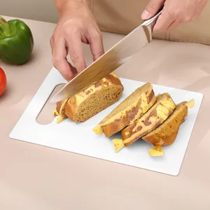 Household non-slip plastic cutting board for kitchen food prep and baby supplement chopping.