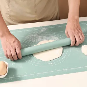 Silicone rolling pin with scale and non-slip baking mat set for home kitchen use.