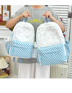 Süßer weißer und blauer gepunkteter Karomuster Schüler Rucksack für Schule und Freizeit.